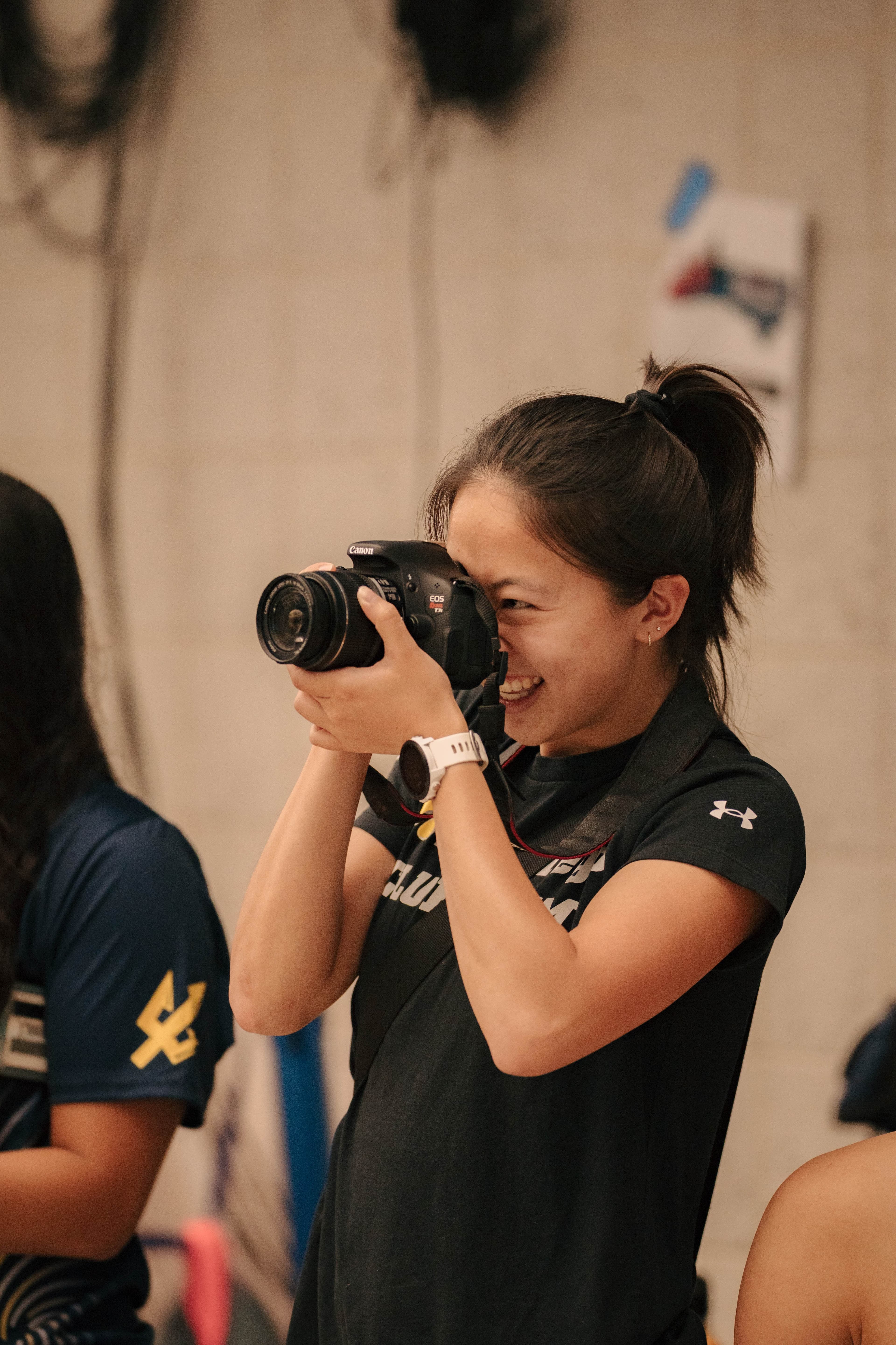 Shannon Chen smiling behind a camera