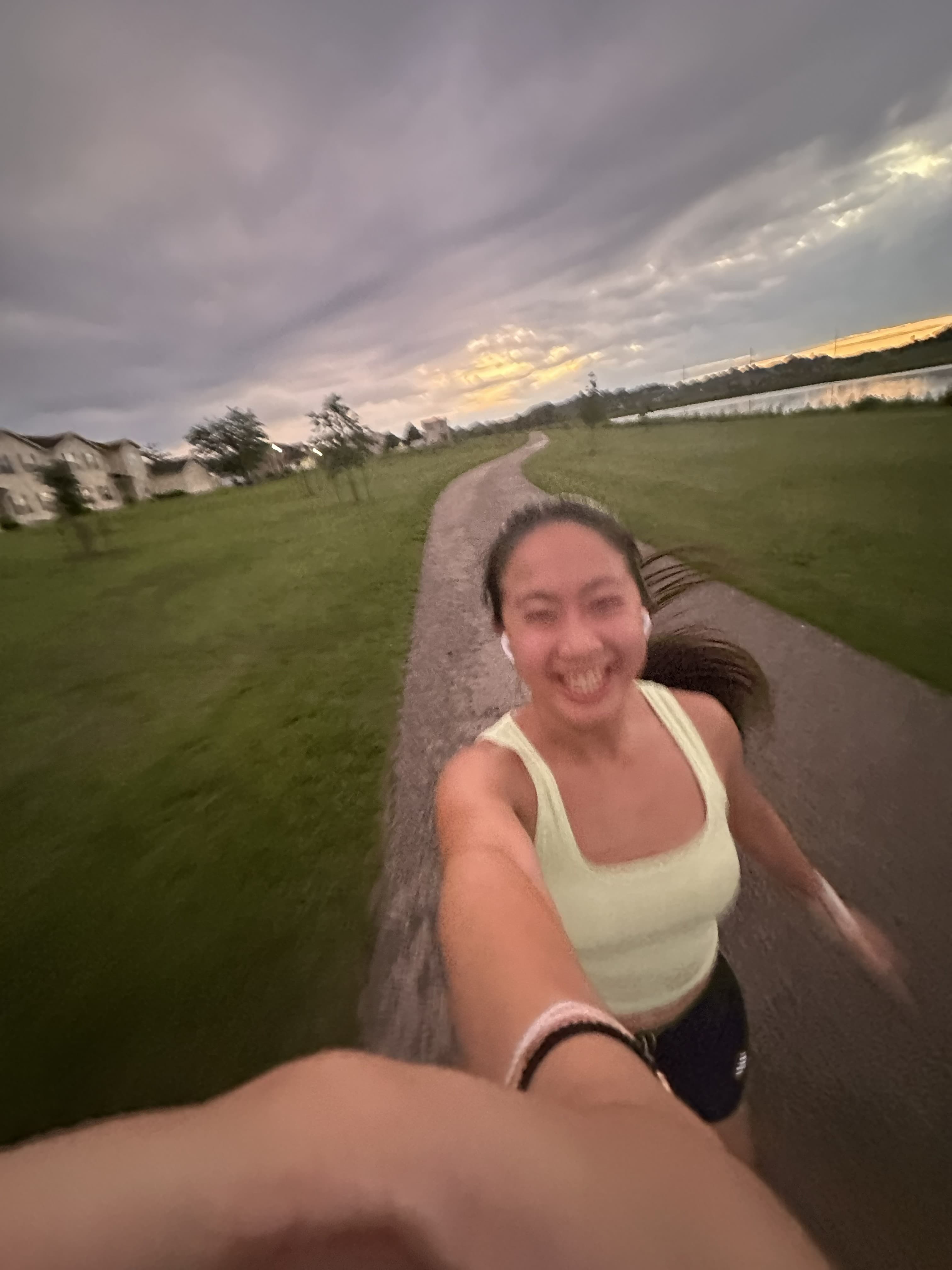 Shannon Chen taking a selfie while running on a path at dusk